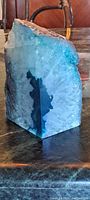 Cut and polished blue crystal rock chunk showing translucent blue and white crystalline formations, polished smooth sides with natural texture on top.