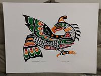 Photograph of the Thunderbird print showing the full artwork with its traditional Northwest Coast Indigenous formline style in black, green, orange, and red.