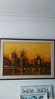 Full view of the oil painting in framed condition hanging on a wall