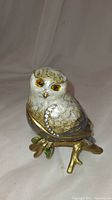 Front and left side view of the owl figurine ring box showing enamel finish and rhinestone wing detail.