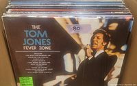 Close-up photo of The Tom Jones Fever Zone vinyl record cover showing the artist singing and listing songs included on the album.