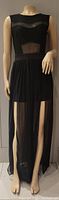 Full front view of sleeveless long black party dress with sheer panel at chest and long sheer skirt with two front slits revealing built-in shorts.