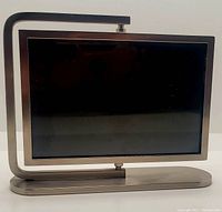 Silver tone metal picture frame on stand, front view showing the frame in horizontal position.