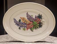 Full view of the large oval platter showing the central lupin floral bouquet design and ribbed border.