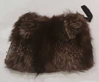 Front view showing brown fox fur texture and wrist strap on the upper right