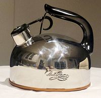 Front view of the polished stainless steel kettle with copper bottom visible and Paul Revere branding.