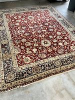 Full view of entire rug on concrete floor showing overall pattern, color and condition