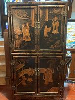 Full frontal view of cabinet showing both upper and lower sets of double doors with decorative panels