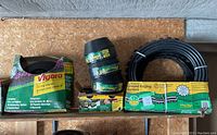Lot shows three types of garden edging products with packaging and coiled black plastic edging pieces.