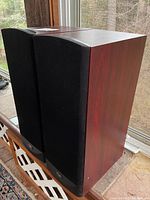 Pair of speakers side by side showing front view with black grilles installed