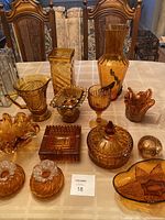 Full set of amber Murano glassware displayed on table, includes vases, pitcher, ashtrays, candy dish and candle holders