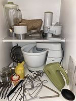 Main photo showing Braun KM32 stand mixer, mixing bowl, shredder and chopper attachments, blender jar, and an assortment of beaters and kitchen tools.