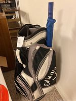 View of the Callaway golf bag with attached stand and umbrella holder, showing carrying handle and padded strap.