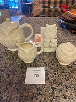 Set of owl ceramic tea items shown on kitchen countertop including teapot, creamer, sugar bowl, owl napkin holder, and salt & pepper shakers.