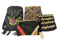 Four vintage purses displayed together: three beaded and one leather clutch with geometric accents.