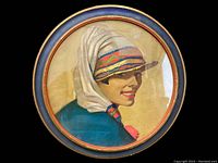 Close-up view of the front showing the colorful framed print of a woman in profile wearing a multicolored hat.