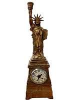 Full front view of the Statue of Liberty lamp with clock, showing its overall design and clock face.