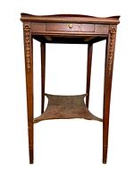 Front view of the Federal style solid wood side table showing carved legs and lower shelf.