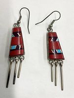 Front view of the pair of Southwestern style earrings with red inlay stones and dangling metal bars.