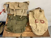 Overview photo showing all three vintage military bags together on a wooden surface.