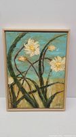Full front view of the flower painting in frame showing white flowers, blue sky, and beige background.