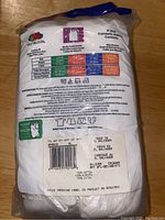 Back of unopened package showing sizing chart, fabric composition, care instructions and country of manufacture (El Salvador).