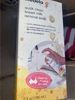 Photo showing Medela Quick Clean Breast Milk Removal Soap box with dirt marks and product information.