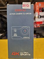 Boxed Cooau CU-SPC06 action camera showing front of packaging with model and 4K Ultra Sports branding.