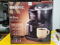 Boxed Keurig K-Duo coffee maker showing front of packaging with product image and branding