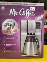 Photo of the original retail box for Mr. Coffee 10 Cup Optimal Brew Programmable Thermal Coffee Maker, showing product image and key features on packaging.