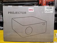Box of a white mini projector with USB, HDMI, and VGA compatibility, displaying the product illustration and model details on the side.