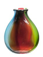Front angled view of the multicolored four-layer glass vase showing the mix of blue, red, green, and black colors.