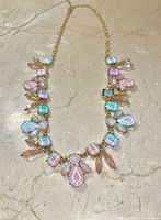 Front view of gold-tone necklace with pastel-colored rose quartz and topaz stones arranged symmetrically.