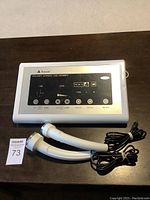 Overall view of ultrasonic beauty instrument with control panel and two probes.