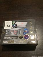 Box front showing VX Gaming Classic System with 2 controllers and 620 games including images of controllers and game characters.