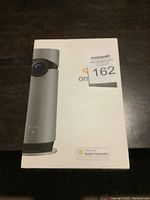 Closed box of D-Link Omna 180 Cam HD showing product photo and Apple HomeKit compatibility on the front.