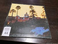 Photo showing front cover of the LP record featuring the iconic Hotel California album cover artwork with sunset and palm trees.