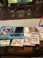 Photo showing boxed items including Wii console, controllers, game discs, and cases arranged on a table.