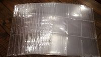 Nineteen clear plastic 9-pocket card pages stacked, showing all nine pockets for cards on each page.