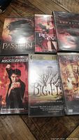 Six DVD movies together: The Passion of the Christ, Resident Evil, The Exorcist, Kiss of the Dragon, Big Fish, and The Time Machine.