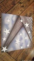 Outer cover of the vinyl record insert booklet showing star designs and rays in a stylized graphic design.