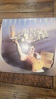 Photo of the front cover of the Supertramp Breakfast in America vinyl album showing the waitress artwork and some wear on the cover.