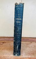 Photo of the book spine showing title 'Landscape Album' with embossed and gold text on a blue binding worn at the top.