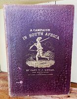 Front cover: purple embossed cloth with gold-stamped title ‘A Campaign in South Africa’ and armed soldier vignette
