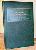Front cover of the dark green Morocco leather bound pictorial atlas with title in Dutch and English embossed in gold.