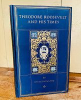 Front cover of the blue hardcover book showing gold embossed title and decorative elements
