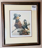 Full framed print showing the artwork of two chickadees, brown wooden frame, cream matting.