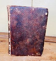 Front cover of the almanac showing brown leather with diamond pattern embossing and wear spots.