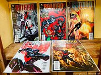 Five Batman Beyond comic books displayed upright and flat, showing front covers.