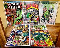 Five Hulk-themed comic books displayed upright, showing front covers with vibrant illustrations, featuring The Sensational She-Hulk, World War Hulk, and The Incredible Hulk.